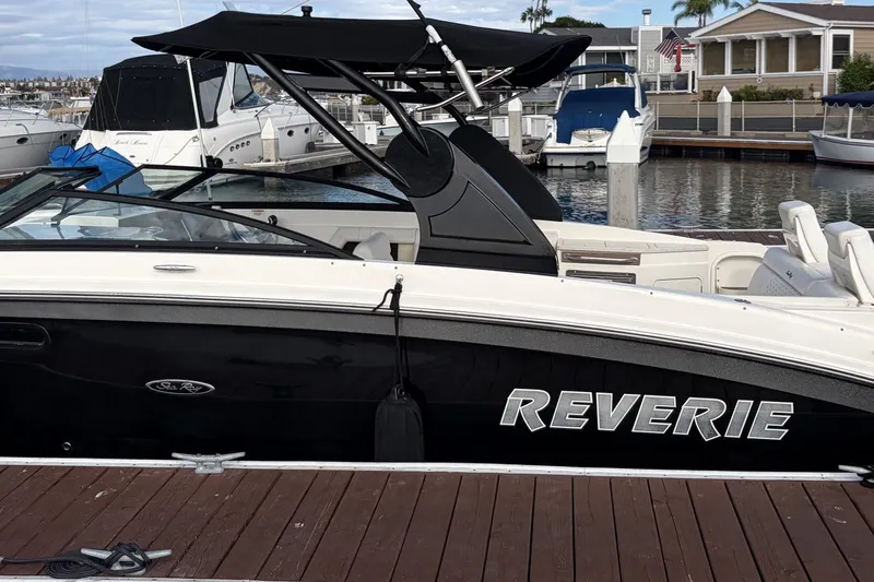 Slide: The Image of 2019 Sea Ray SDX 290 Outboard boat named "Reverie" docked at a marina. - 5