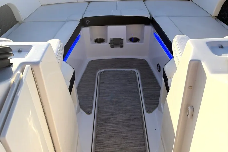 Slide: The Image of 2019 Sea Ray SDX 290 Outboard boat interior with cushioned seating and blue LED lighting. - 32