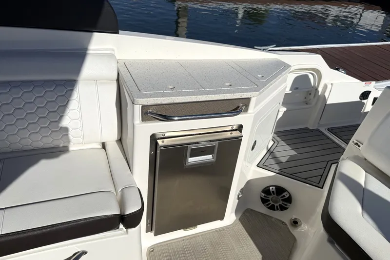 Slide: The Image of 2019 Sea Ray SDX 290 Outboard interior with seating, countertop, and storage. - 18