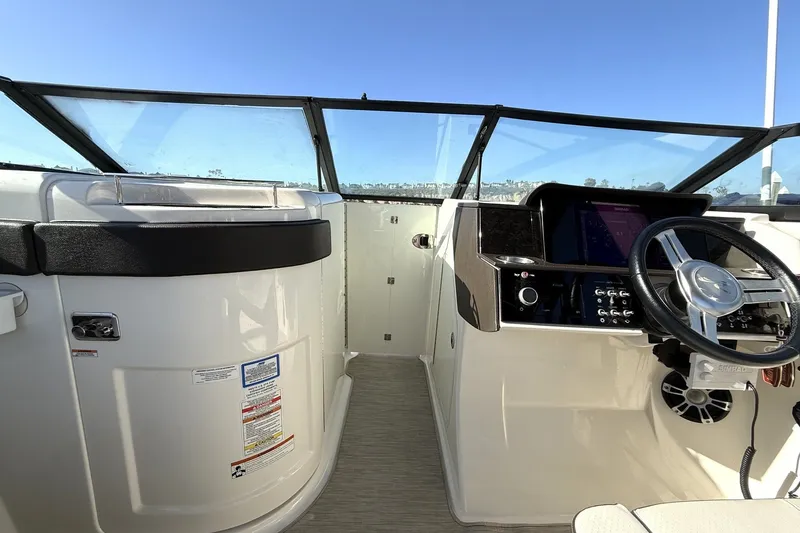 Slide: The Image of 2019 Sea Ray SDX 290 Outboard helm with steering wheel and control panel. - 29