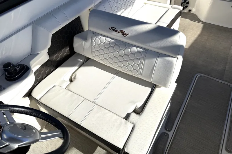 Slide: The Image of 2019 Sea Ray SDX 290 Outboard interior with luxurious white seating and steering wheel. - 23