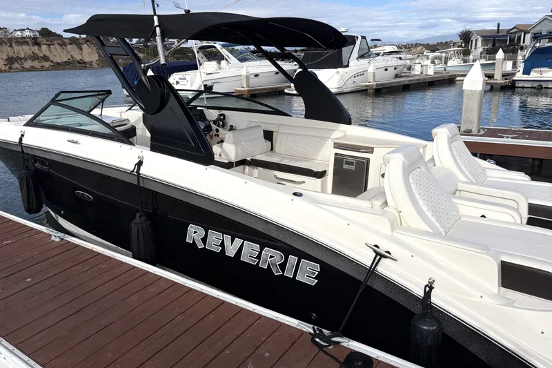 Slide: The Image of 2019 Sea Ray SDX 290 Outboard boat docked, featuring sleek design and comfortable seating. - 4