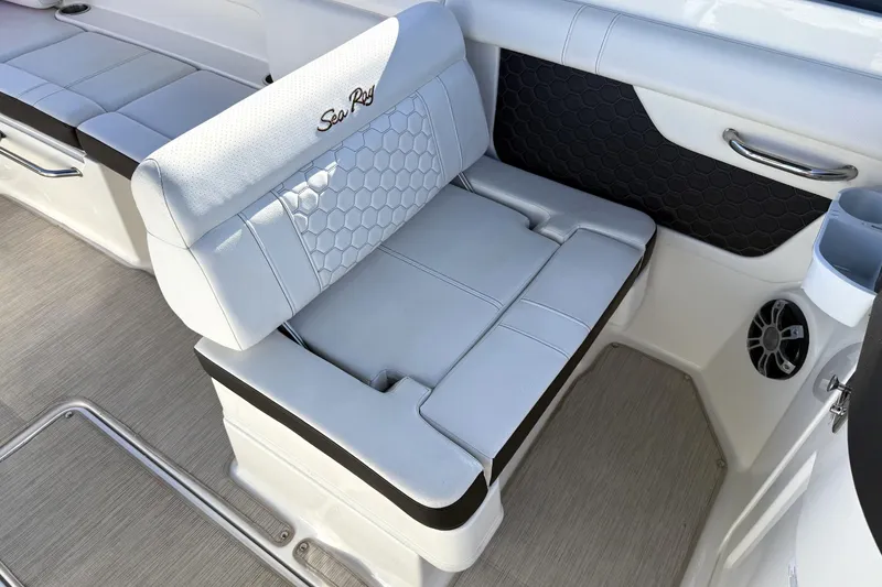 Slide: The Image of 2019 Sea Ray SDX 290 Outboard boat interior with white cushioned seating. - 21