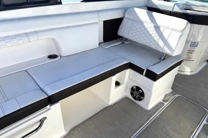 Slide: The Image of 2019 Sea Ray SDX 290 Outboard interior with white cushioned seating and speaker. - 20