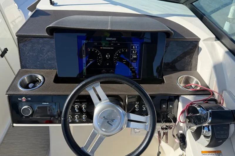 Slide: The Image of 2019 Sea Ray SDX 290 Outboard dashboard with steering wheel and navigation display. - 27