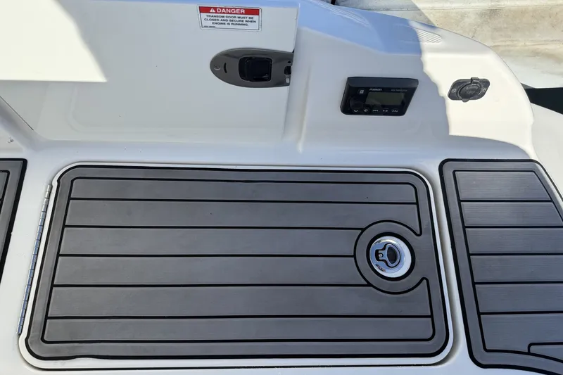 Slide: The Image of 2019 Sea Ray SDX 290 Outboard deck with control panel and warning label. - 11