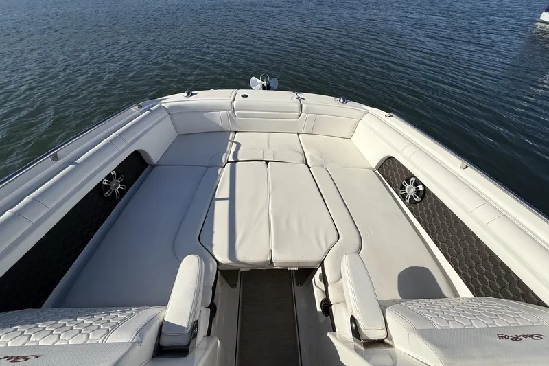 Slide: The Image of 2019 Sea Ray SDX 290 Outboard boat interior with white seating on calm water. - 34