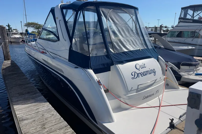 Slide: The Image of 2003 Formula 37 Performance Cruiser docked, featuring "Quit Dreaming" on the stern. - 2