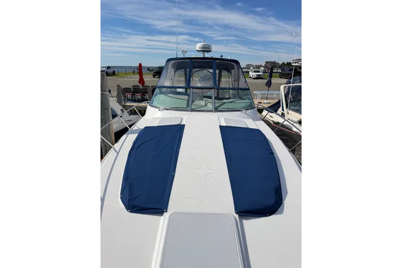 Slide: The Image of 2003 Formula 37 Performance Cruiser docked, featuring blue sun pads and clear skies. - 11