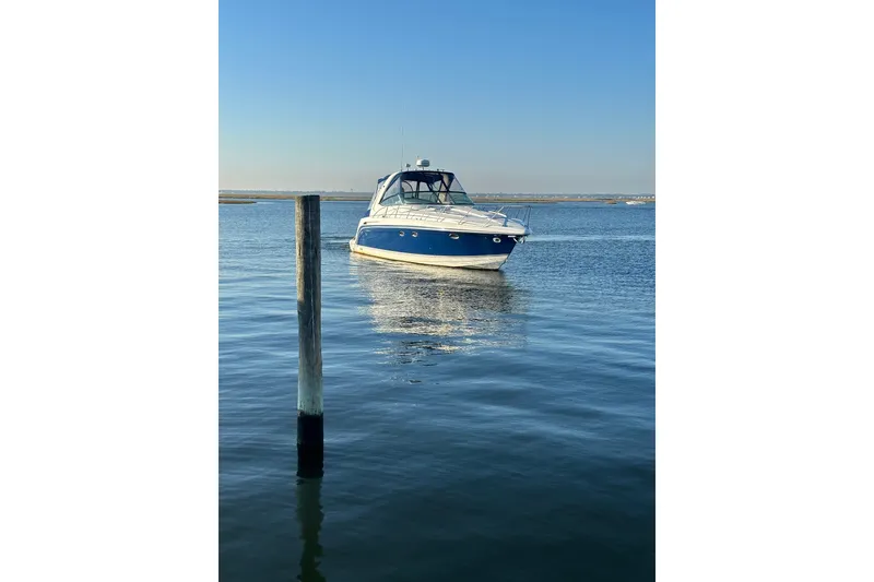 Slide: The Image of 2003 Formula 37 Performance Cruiser on calm water under clear blue sky. - 1