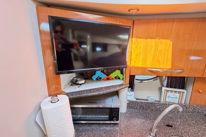 Slide: The Image of 2003 Formula 37 Performance Cruiser interior with TV, paper towel holder, and countertop appliances. - 31
