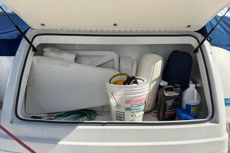 Slide: The Image of Storage compartment of a 2003 Formula 37 Performance Cruiser with various boating supplies. - 14