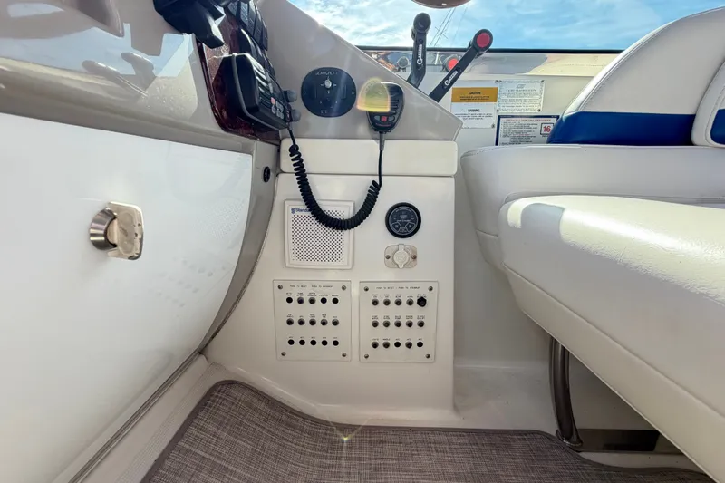 Slide: The Image of Control panel of a 2003 Formula 37 Performance Cruiser with switches and communication devices. - 27