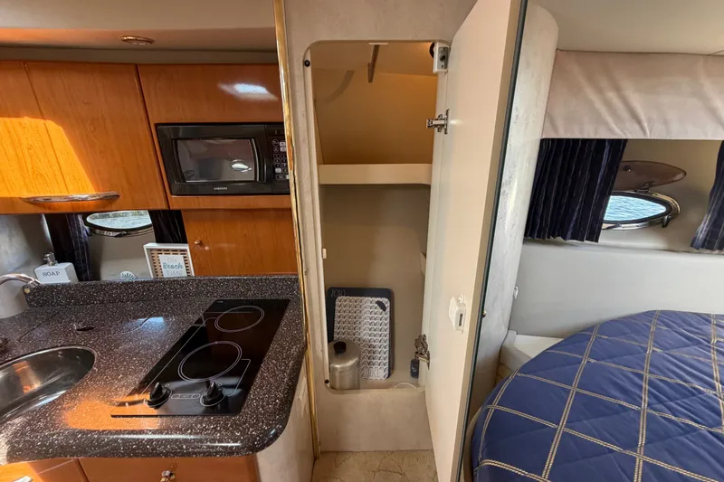 Slide: The Image of Interior of a 2003 Formula 37 Performance Cruiser with kitchen and sleeping area. - 35