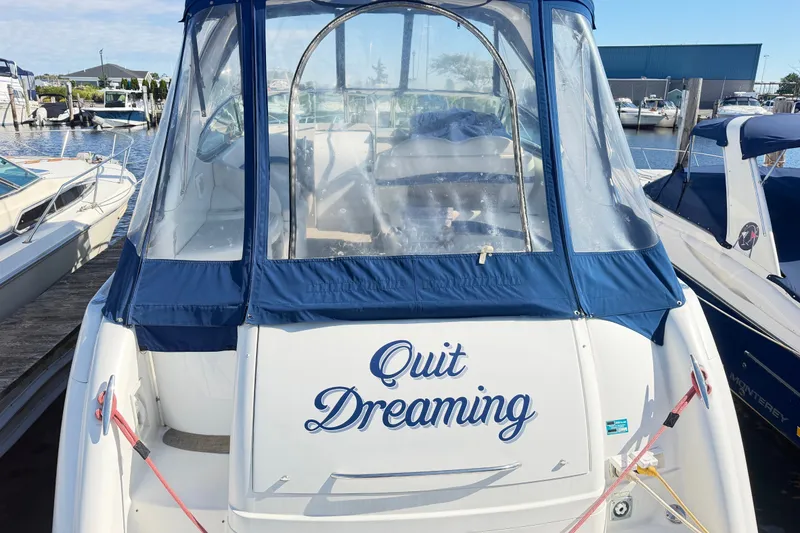 Slide: The Image of 2003 Formula 37 Performance Cruiser docked, featuring "Quit Dreaming" text on the stern. - 3