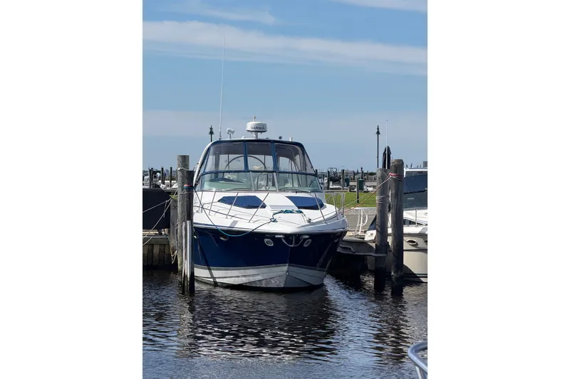 Slide: The Image of 2003 Formula 37 Performance Cruiser docked at marina under clear blue sky. - 6