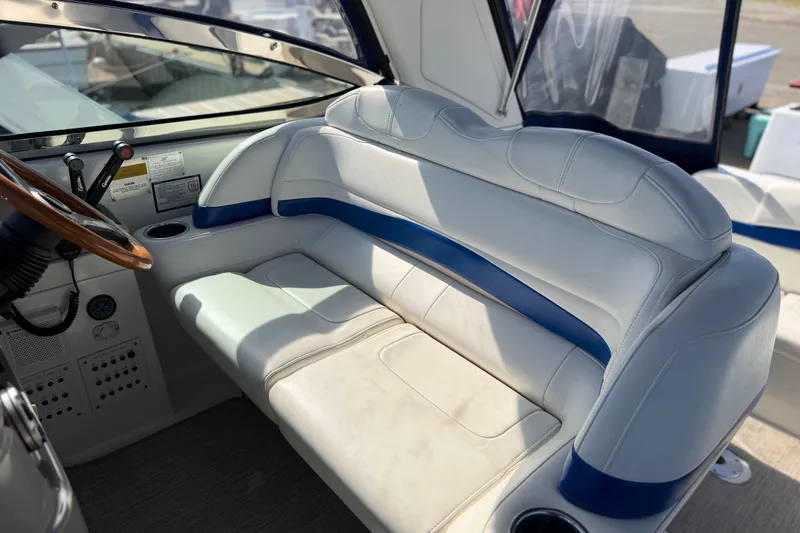 Slide: The Image of 2003 Formula 37 Performance Cruiser cockpit with white and blue seating, wooden steering wheel. - 21