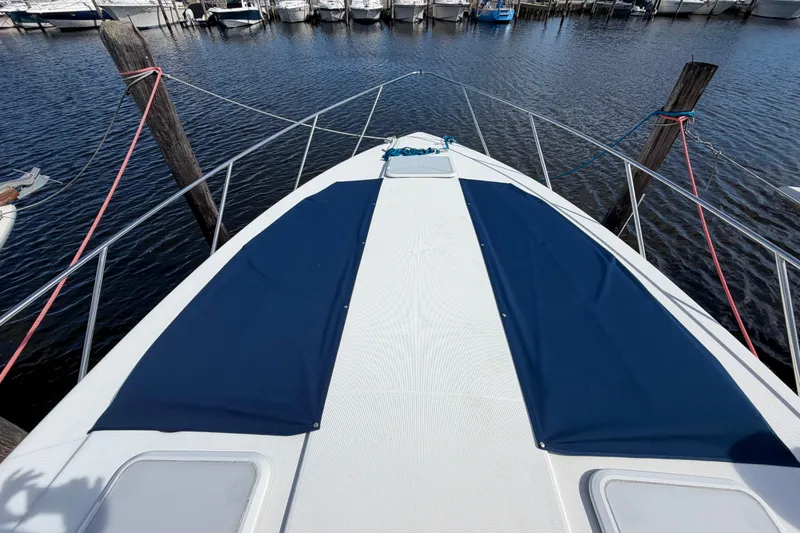 Slide: The Image of 2003 Formula 37 Performance Cruiser docked at marina, featuring sleek deck design. - 7