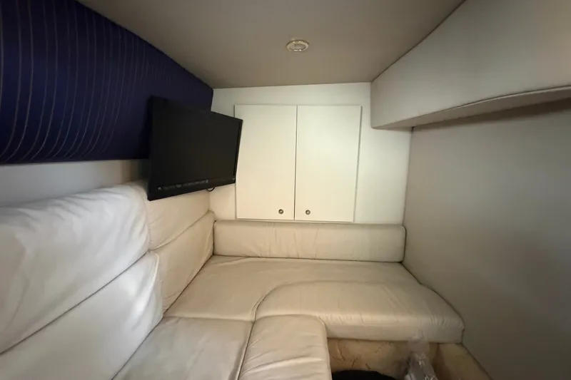 Slide: The Image of Interior of 2003 Formula 37 Performance Cruiser with white seating and wall-mounted TV. - 46