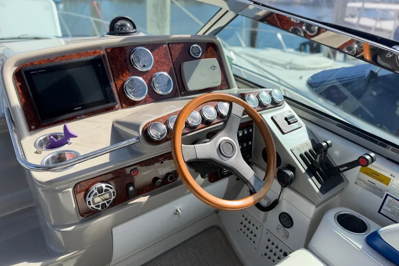 Slide: The Image of 2003 Formula 37 Performance Cruiser helm with wood accents and modern controls. - 22