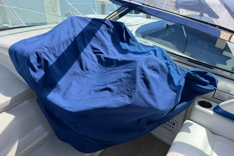 Slide: The Image of Blue cover on a 2003 Formula 37 Performance Cruiser dashboard, docked by the water. - 26