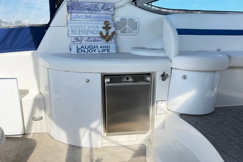 Slide: The Image of 2003 Formula 37 Performance Cruiser interior with seating, mini fridge, and motivational signs. - 17