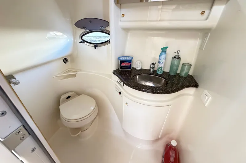 Slide: The Image of 2003 Formula 37 Performance Cruiser bathroom with sink, toilet, and porthole window. - 48
