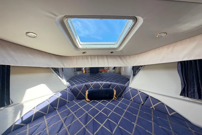 Slide: The Image of Interior of 2003 Formula 37 Performance Cruiser with skylight and blue patterned bedding. - 39
