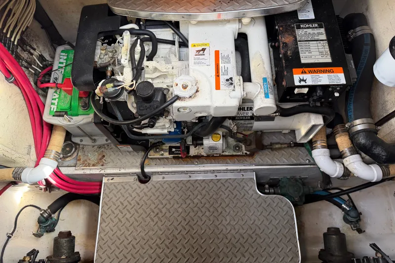Slide: The Image of Engine compartment of a 2003 Formula 37 Performance Cruiser with Kohler generator and battery. - 58