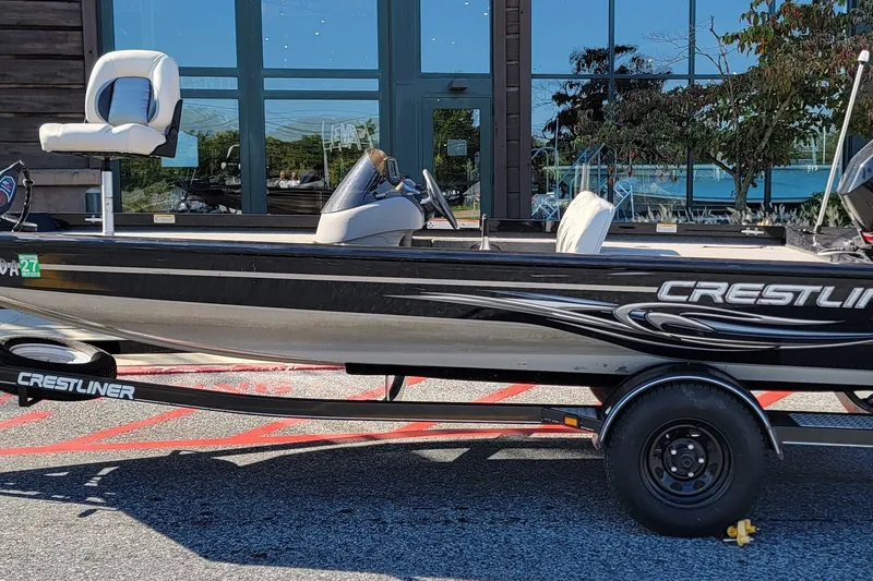 The Image of 2008 Crestliner CX 17 Bass boat on trailer, parked outdoors. - 0