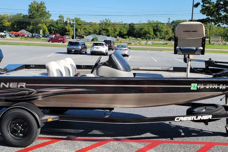 Slide: The Image of 2008 Crestliner CX 17 Bass boat on trailer in parking lot, side view. - 2