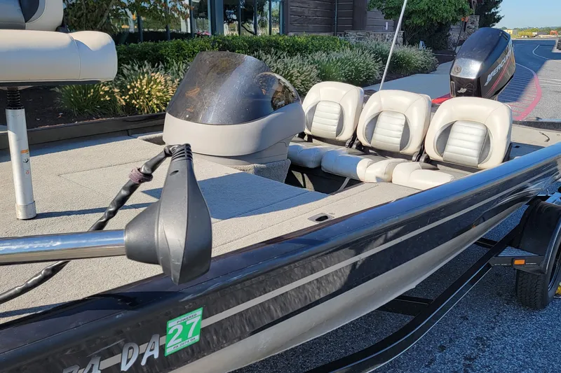 Slide: The Image of 2008 Crestliner CX 17 Bass boat with seating and motor, parked outdoors. - 8
