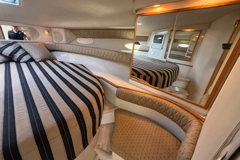 Slide: The Image of Luxurious interior of 1996 Sea Ray Sundancer 370 yacht with striped bedding and mirrored walls. - 53