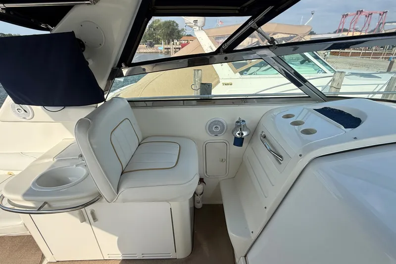 Slide: The Image of Interior of a 1996 Sea Ray Sundancer 370 boat with white seating and helm station. - 29