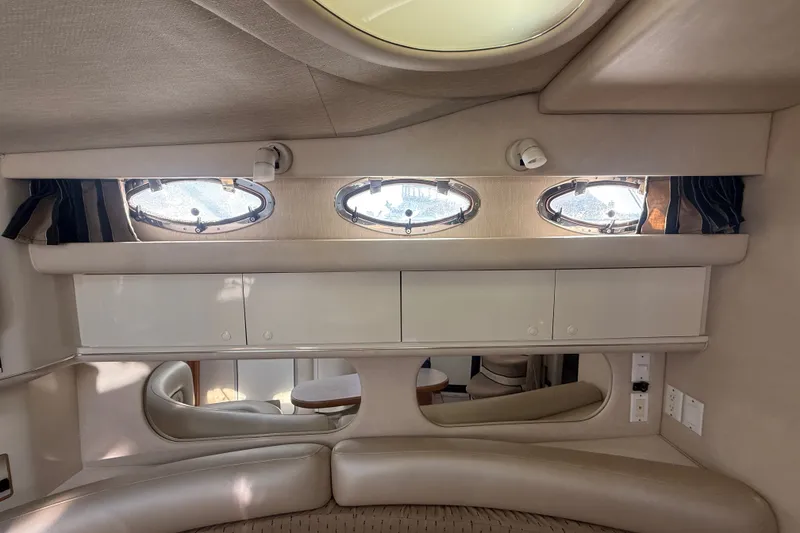 Slide: The Image of Interior of 1996 Sea Ray Sundancer 370 yacht with portholes and seating area. - 45