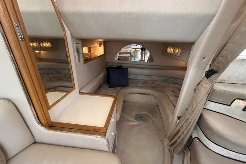Slide: The Image of Interior cabin of 1996 Sea Ray Sundancer 370, featuring cozy seating and elegant wood accents. - 58