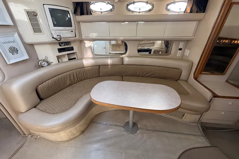 Slide: The Image of Interior of 1996 Sea Ray Sundancer 370 yacht with curved seating and table. - 43