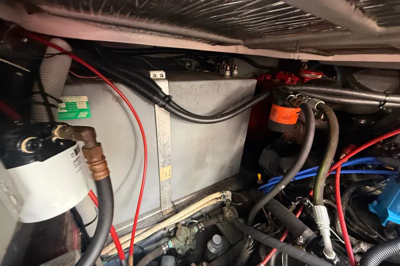 Slide: The Image of Engine compartment of a 1996 Sea Ray Sundancer 370 with visible wiring and components. - 72