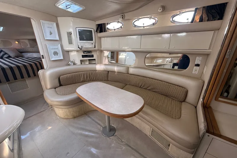 Slide: The Image of Interior of a 1996 Sea Ray Sundancer 370 yacht with a cozy seating area. - 42