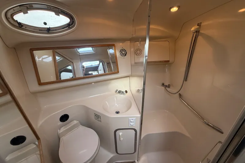Slide: The Image of Bathroom interior of 1996 Sea Ray Sundancer 370 yacht, featuring sink, toilet, and shower. - 51