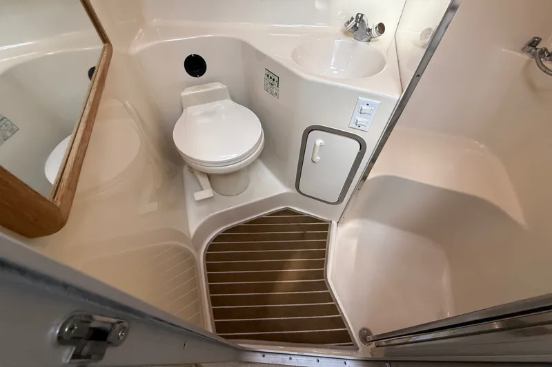 Slide: The Image of Bathroom interior of 1996 Sea Ray Sundancer 370 yacht, featuring toilet, sink, and shower. - 47