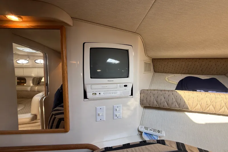 Slide: The Image of 1996 Sea Ray Sundancer 370 cabin interior with vintage TV and cozy seating area. - 55