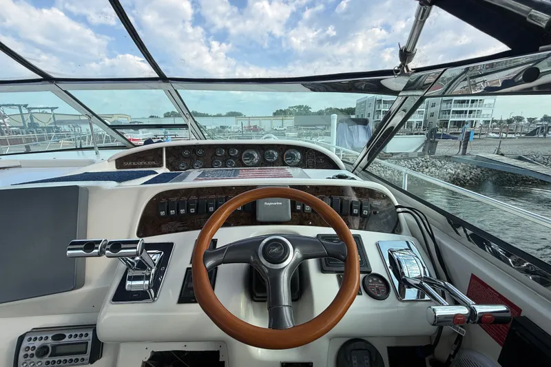 Slide: The Image of 1996 Sea Ray Sundancer 370 helm with wooden steering wheel and control panel. - 19