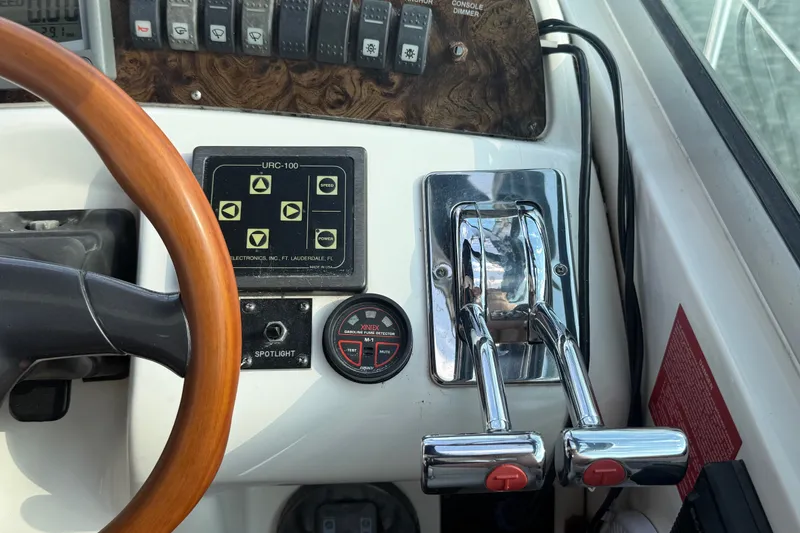 Slide: The Image of Control panel of a 1996 Sea Ray Sundancer 370 with steering wheel and throttle levers. - 26