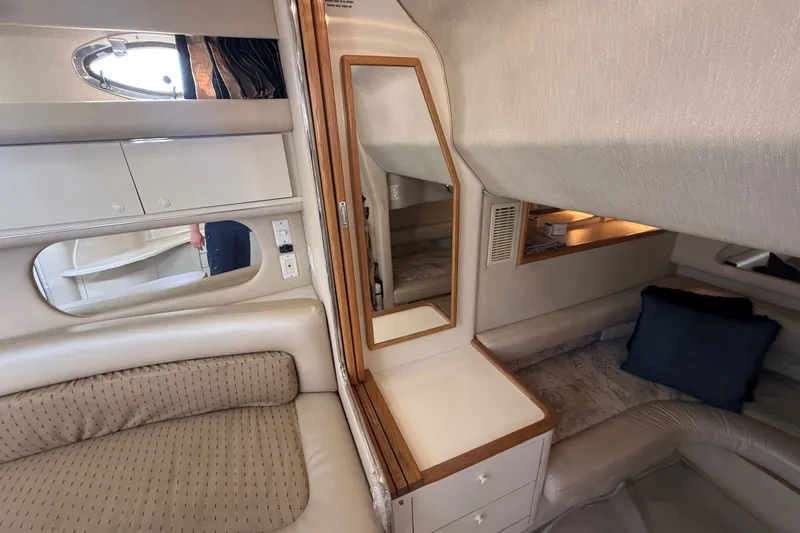 Slide: The Image of 1996 Sea Ray Sundancer 370 cabin interior with mirror, seating, and storage. - 59