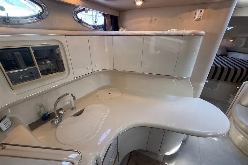 Slide: The Image of Interior of 1996 Sea Ray Sundancer 370 yacht, featuring a sleek kitchen area with modern amenities. - 40