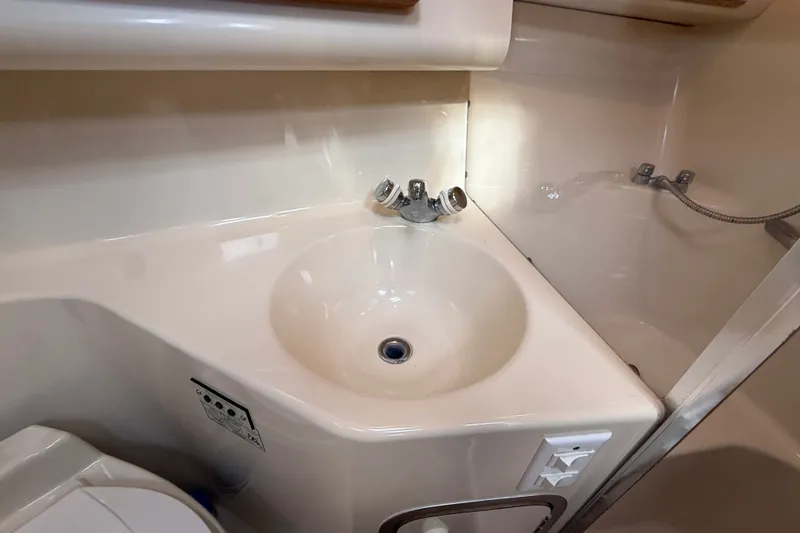 Slide: The Image of Bathroom sink and shower area in a 1996 Sea Ray Sundancer 370 yacht. - 49