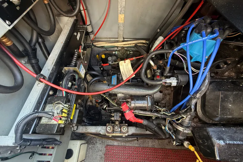 Slide: The Image of Engine compartment of a 1996 Sea Ray Sundancer 370 with visible wiring and components. - 66