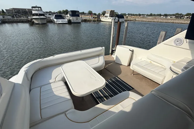 Slide: The Image of Spacious deck of 1996 Sea Ray Sundancer 370 with comfortable seating and table. - 28