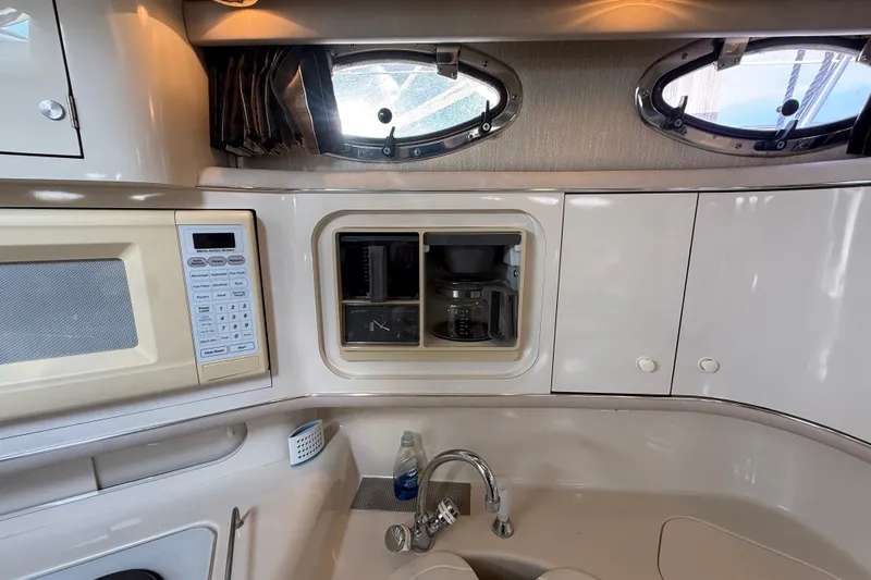Slide: The Image of Interior of 1996 Sea Ray Sundancer 370 with kitchenette, microwave, and coffee maker. - 39